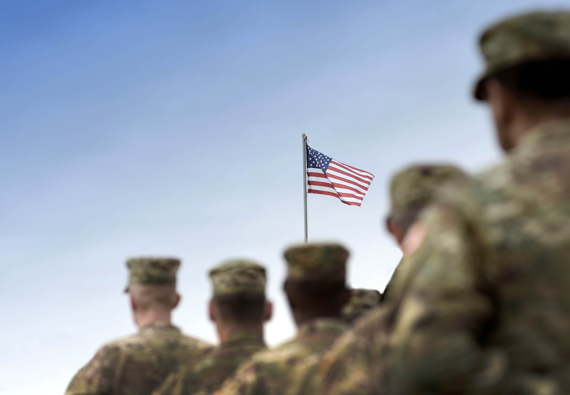 Soldiers saluting the flag