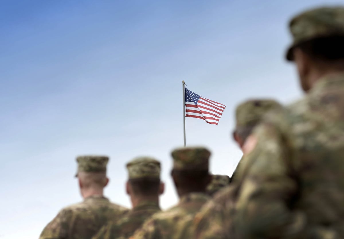Soldiers saluting the flag