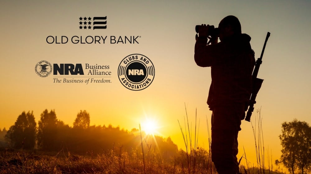 Hunter in field at sunrise